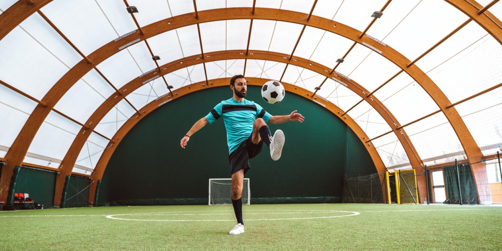 Cinematic image of a soccer freestyle player making tricks with the ball.