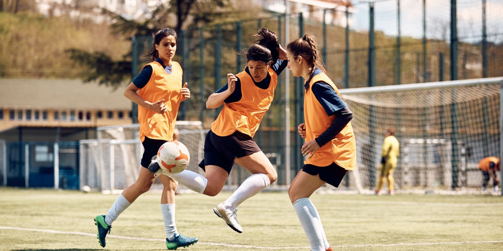 Skillful female soccer player in action during sports training at the stadium.