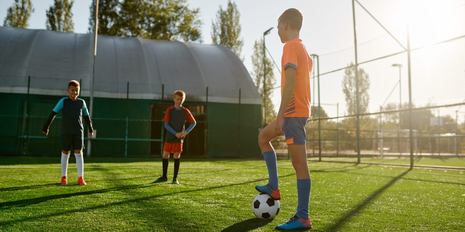 Young boys in sports soccer club on training unit improving skills